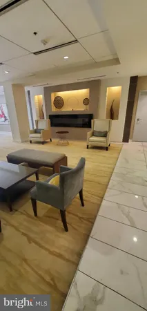 a living room with chairs and a table
