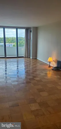 a view of an empty room with glass door