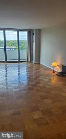 a view of an empty room with glass door