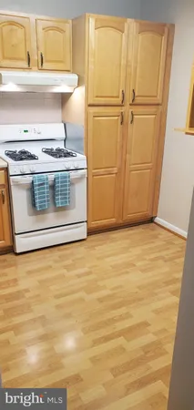 a stove top oven sitting inside of a kitchen