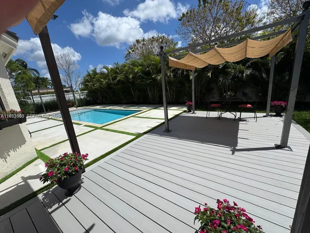 a view of wooden floor and a chandelier fan in a room