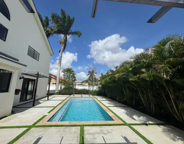 an aerial view of a house with a swimming pool