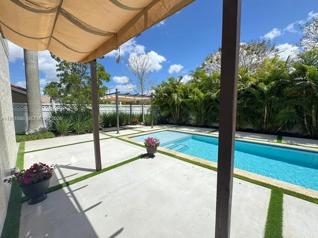 an aerial view of a house with a yard and sitting area