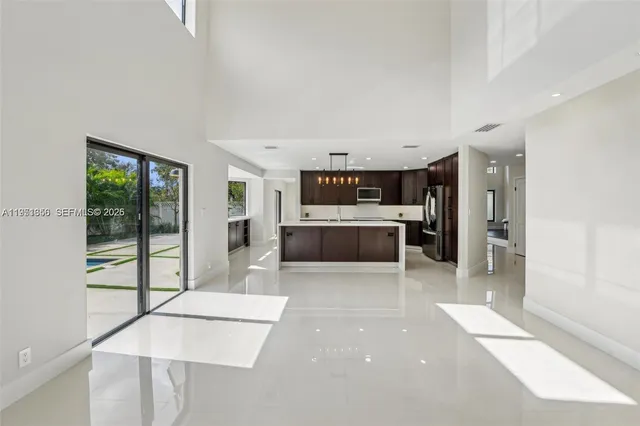 a kitchen with stainless steel appliances granite countertop a sink and a stove