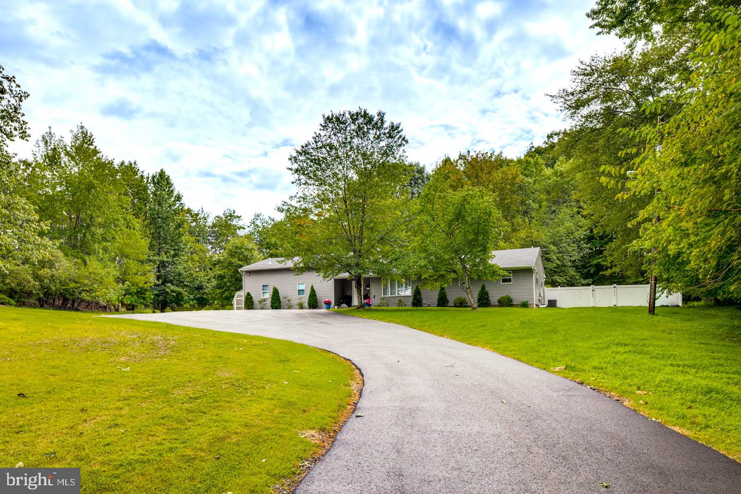 332 Juliustown Road Columbus, NJ 08022 - Photo 2 of 65 a view of a swimming pool with lawn chairs and a big yard