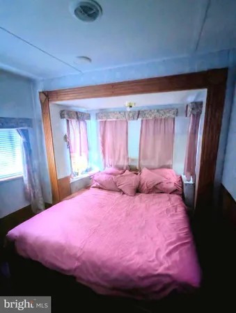 a bed room with a bed and a mirror