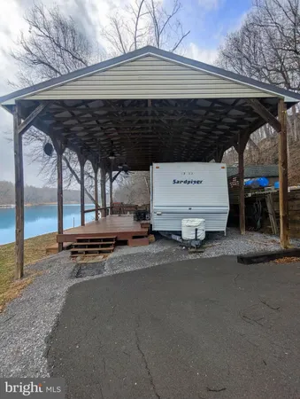 a view of a patio with table and chairs a barbeque with wooden fence