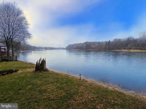 a view of a lake with houses in the back