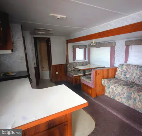 a kitchen with stainless steel appliances kitchen island granite countertop wooden cabinets and sink