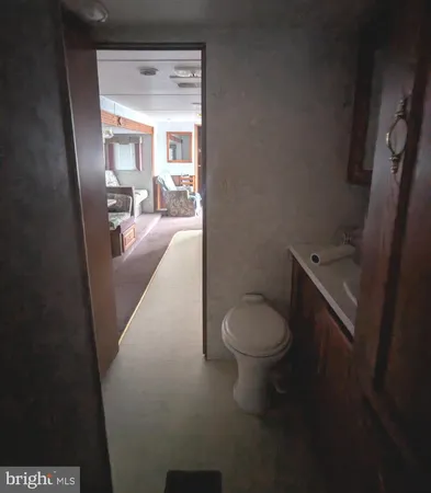 a bathroom with a toilet a sink and a mirror