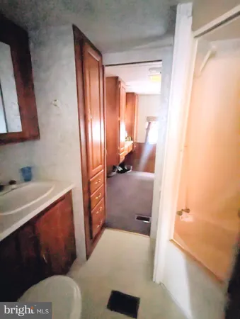 a bathroom with a sink a toilet and a mirror