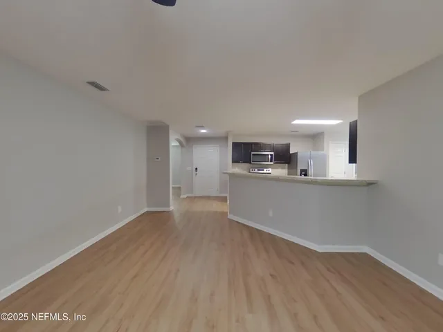 a view of a kitchen with a sink and a window