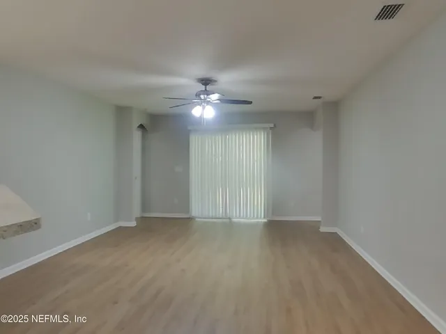 a view of an empty room with a window