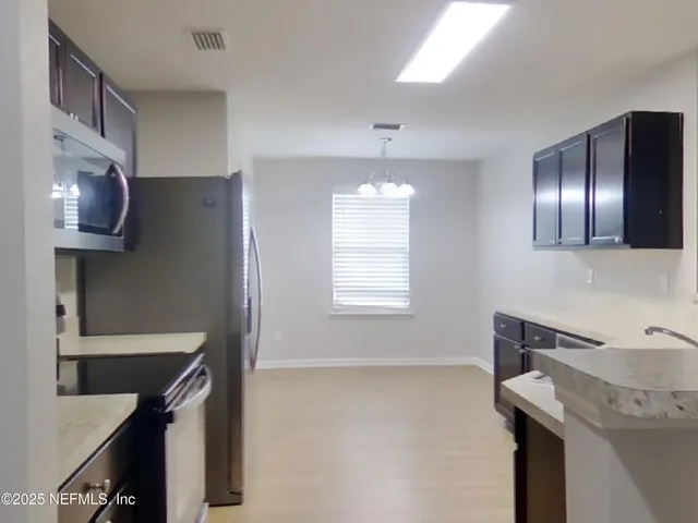 a kitchen that has a sink and a stove in it