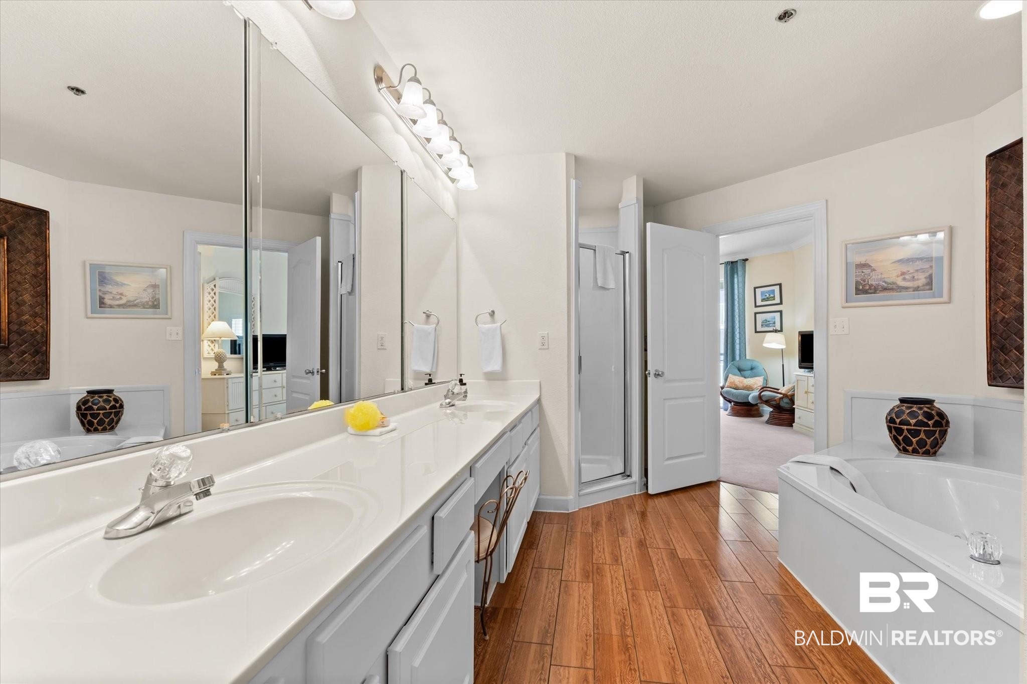 27770 Canal Road, Unit 2304 Orange Beach, AL 36561 - Photo 15 of 30 Bathroom with a bath, double vanity, a sink, and wood finished floors