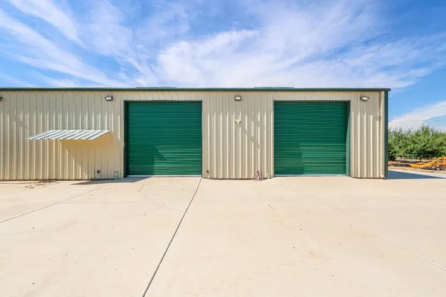 a view of a yard with trees on both side of it