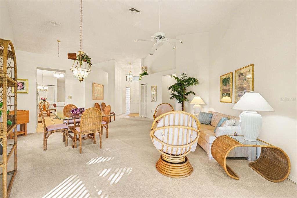 9130 Bassett Lane New Port Richey, FL 34655 - Photo 11 of 41 a living room with patio chairs and a chandelier