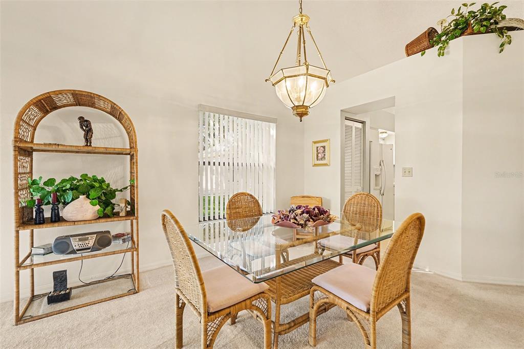 9130 Bassett Lane New Port Richey, FL 34655 - Photo 14 of 41 a view of a dining room with furniture wooden floor and chandelier