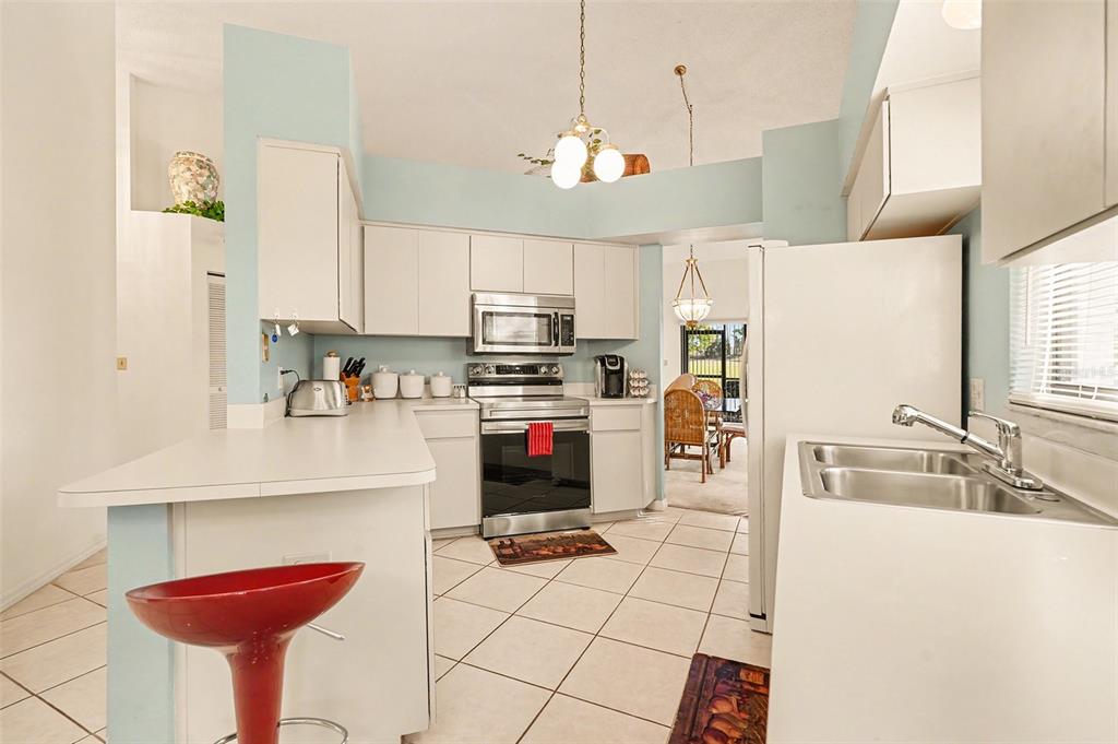 9130 Bassett Lane New Port Richey, FL 34655 - Photo 15 of 41 a kitchen with stainless steel appliances granite countertop a sink and a refrigerator