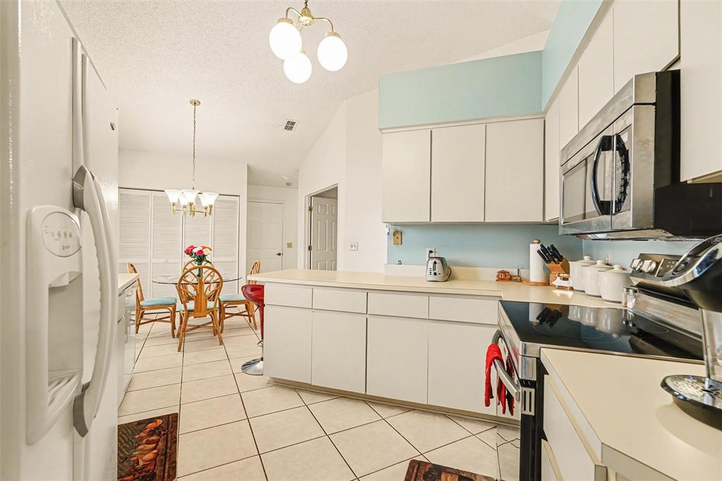 9130 Bassett Lane New Port Richey, FL 34655 - Photo 17 of 41 a kitchen filled with white cabinets and appliances