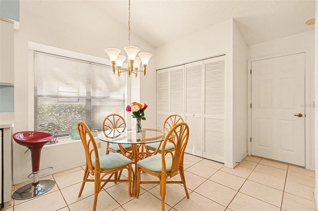 9130 Bassett Lane New Port Richey, FL 34655 - Photo 19 of 41 a view of a dining room with furniture and chandelier