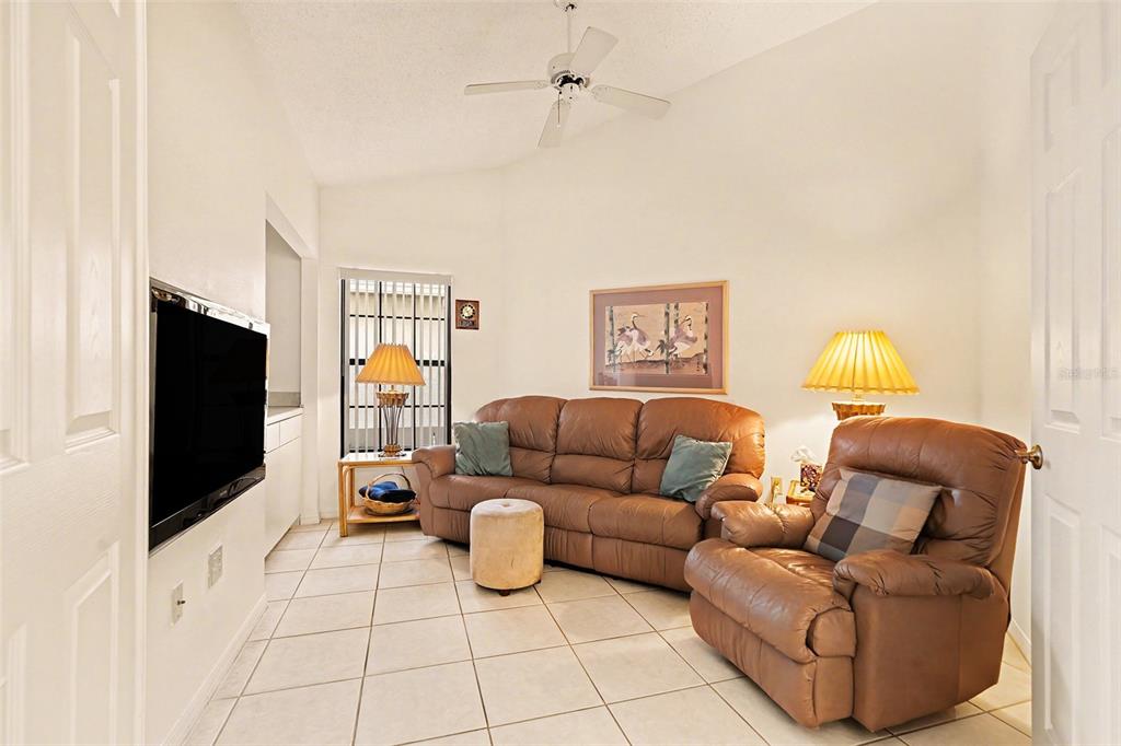 9130 Bassett Lane New Port Richey, FL 34655 - Photo 21 of 41 a living room with furniture and a flat screen tv