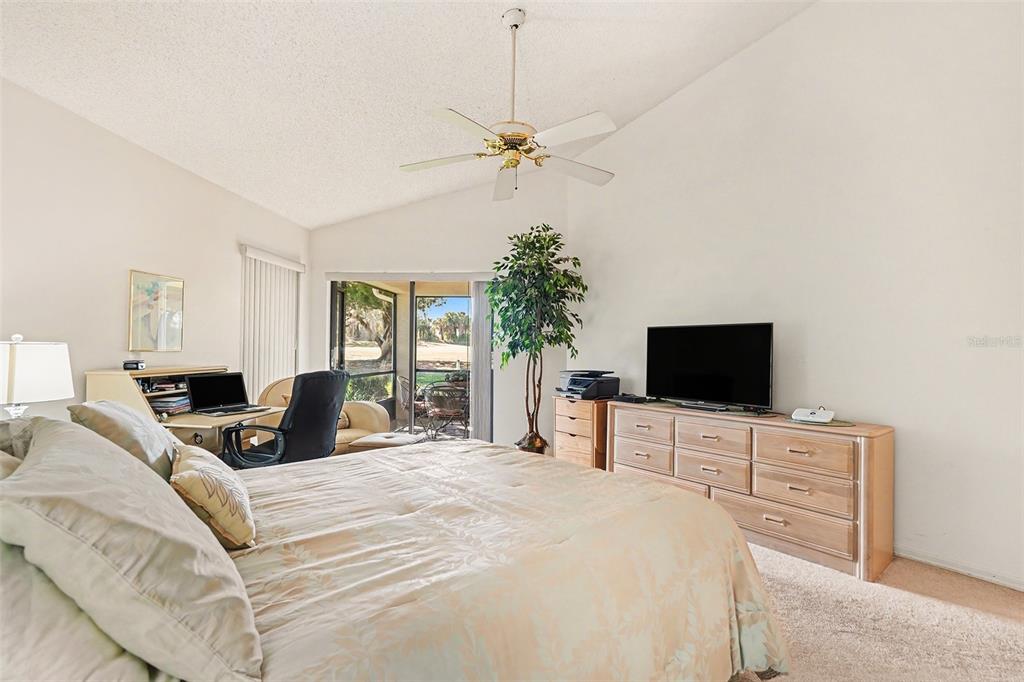 9130 Bassett Lane New Port Richey, FL 34655 - Photo 22 of 41 a bedroom with a bed and a flat screen tv
