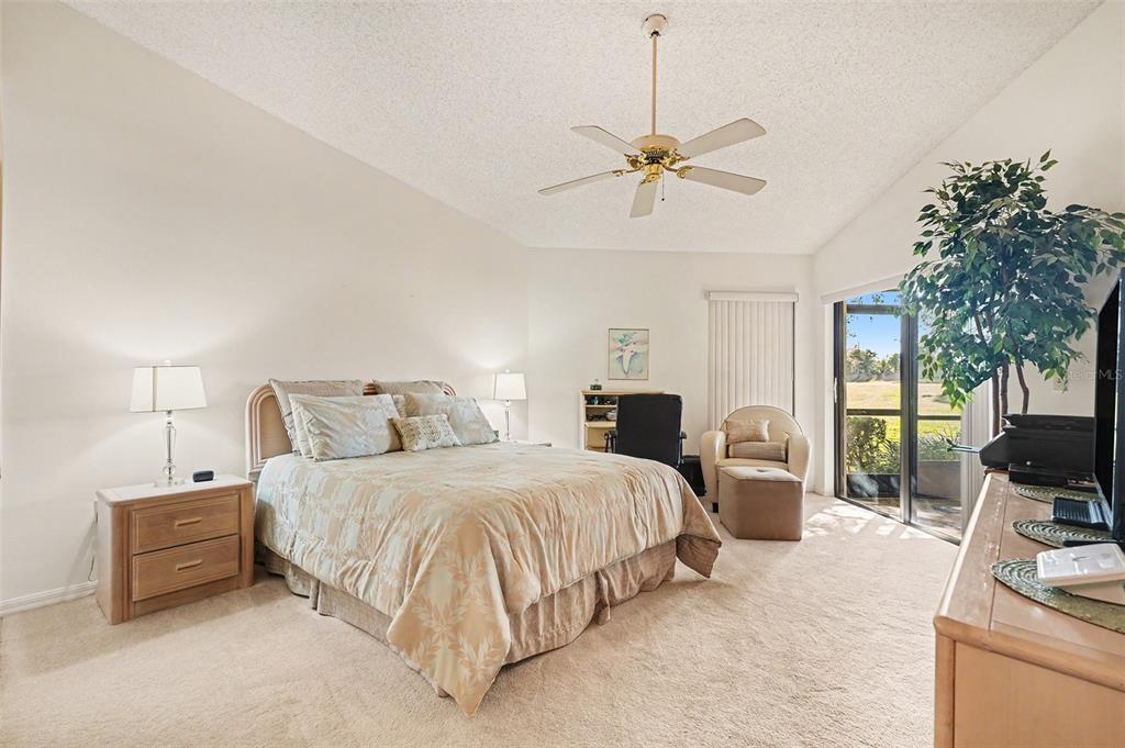 9130 Bassett Lane New Port Richey, FL 34655 - Photo 23 of 41 a bedroom with bed couches and flat tv screen