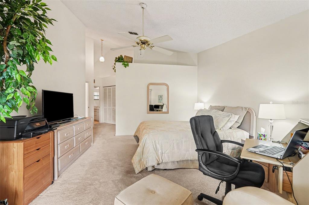 9130 Bassett Lane New Port Richey, FL 34655 - Photo 24 of 41 a bedroom with furniture and a flat screen tv