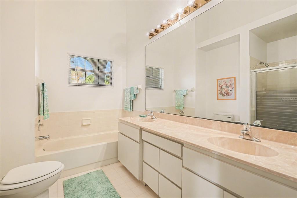 9130 Bassett Lane New Port Richey, FL 34655 - Photo 25 of 41 a bathroom with a sink a toilet and shower