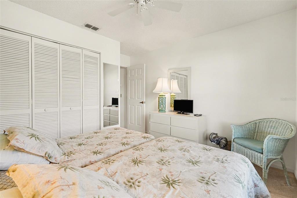 9130 Bassett Lane New Port Richey, FL 34655 - Photo 26 of 41 a bedroom with a bed and a chair