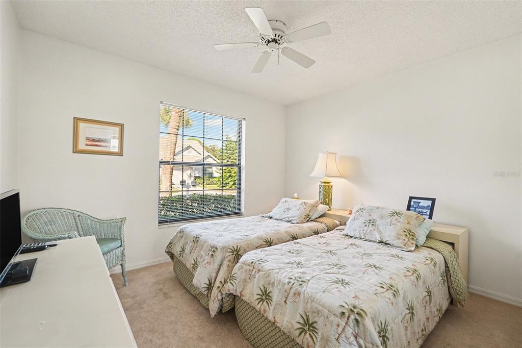 9130 Bassett Lane New Port Richey, FL 34655 - Photo 27 of 41 a bedroom with two beds and a window