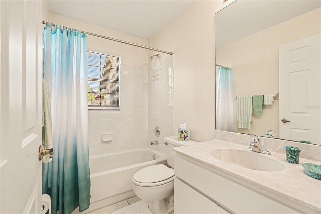 9130 Bassett Lane New Port Richey, FL 34655 - Photo 28 of 41 a bathroom with a granite countertop sink toilet and shower