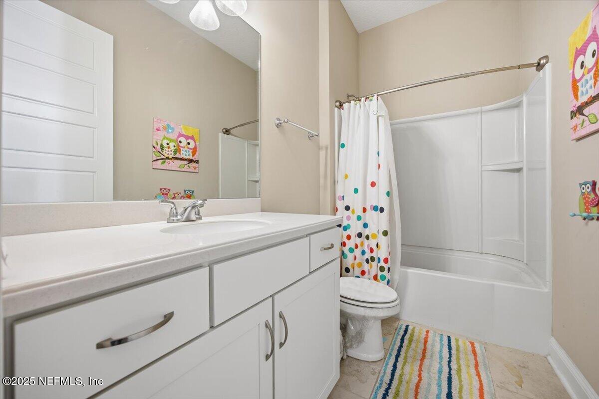 230 Julep Street Yulee, FL 32097 - Photo 14 of 24 a bathroom with a sink a toilet and shower