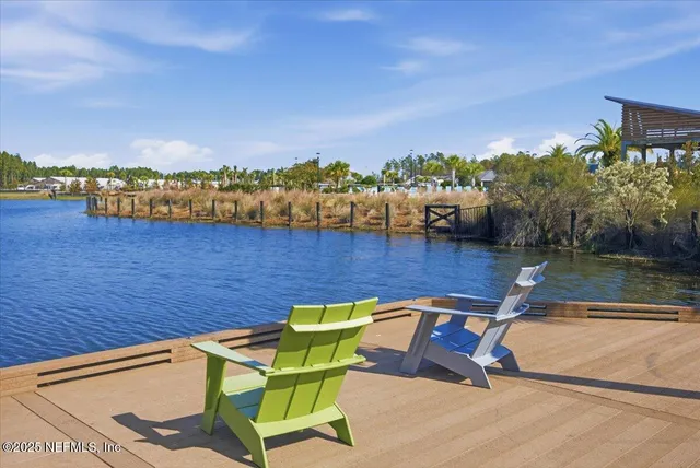 a view of a lake with couches chairs