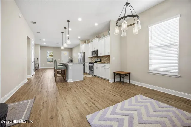 a living room with stainless steel appliances kitchen island granite countertop furniture and a kitchen view