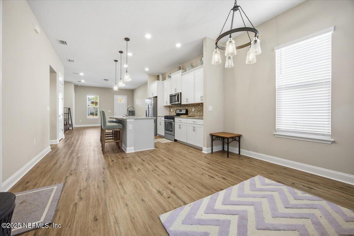 230 Julep Street Yulee, FL 32097 - Photo 8 of 24 a living room with stainless steel appliances kitchen island granite countertop furniture and a kitchen view