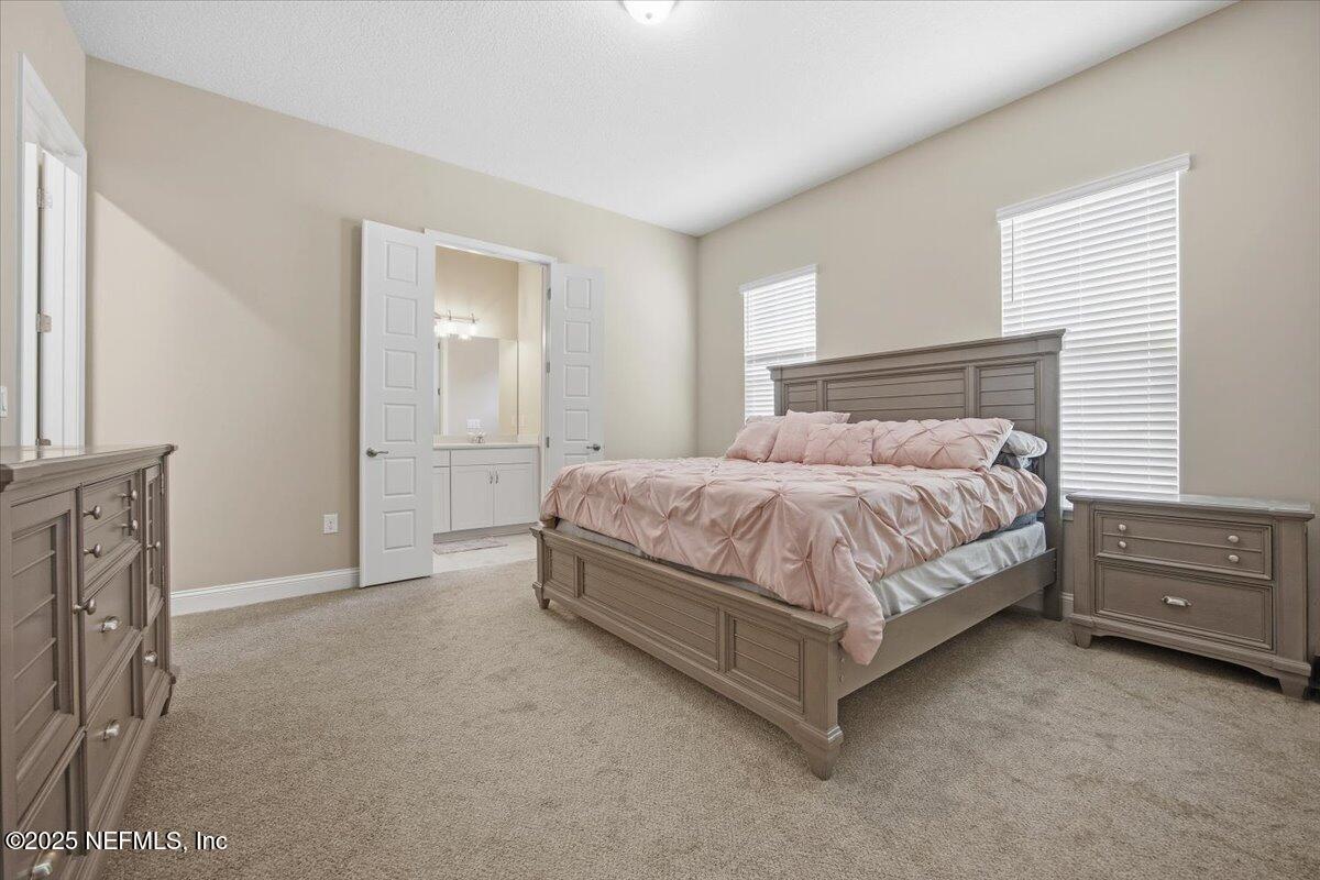 230 Julep Street Yulee, FL 32097 - Photo 9 of 24 a bedroom with a bed and dresser