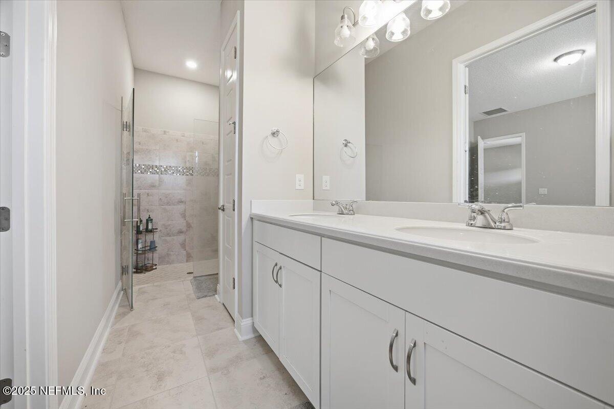 230 Julep Street Yulee, FL 32097 - Photo 10 of 24 a bathroom with a double vanity sink mirror and shower