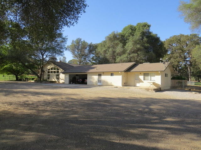 17410 Bowman Road Cottonwood, CA 96022 - Photo 1 of 24 a front view of a house with a yard and garage