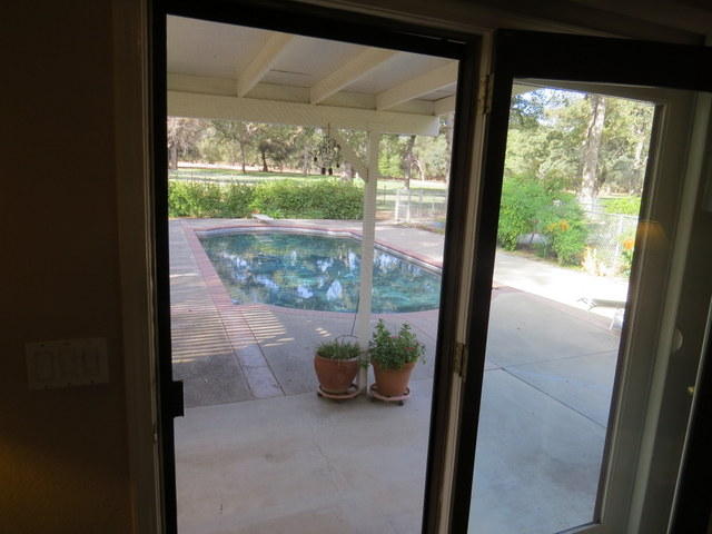 17410 Bowman Road Cottonwood, CA 96022 - Photo 9 of 24 a view of a glass door and a porch