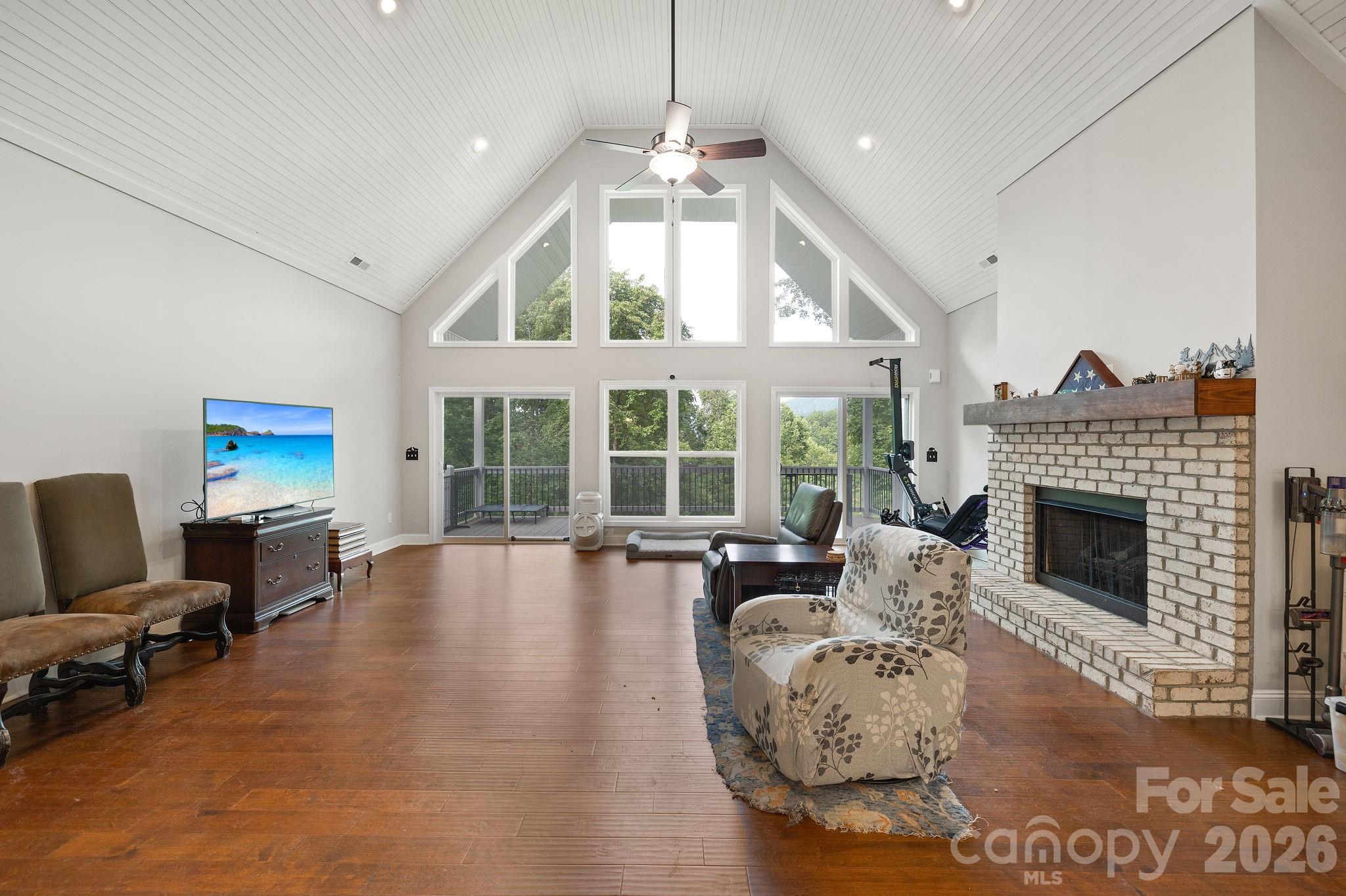 771 Sally Gap Road Old Fort, NC 28762 - Photo 13 of 44 a living room with furniture a fireplace and a large window