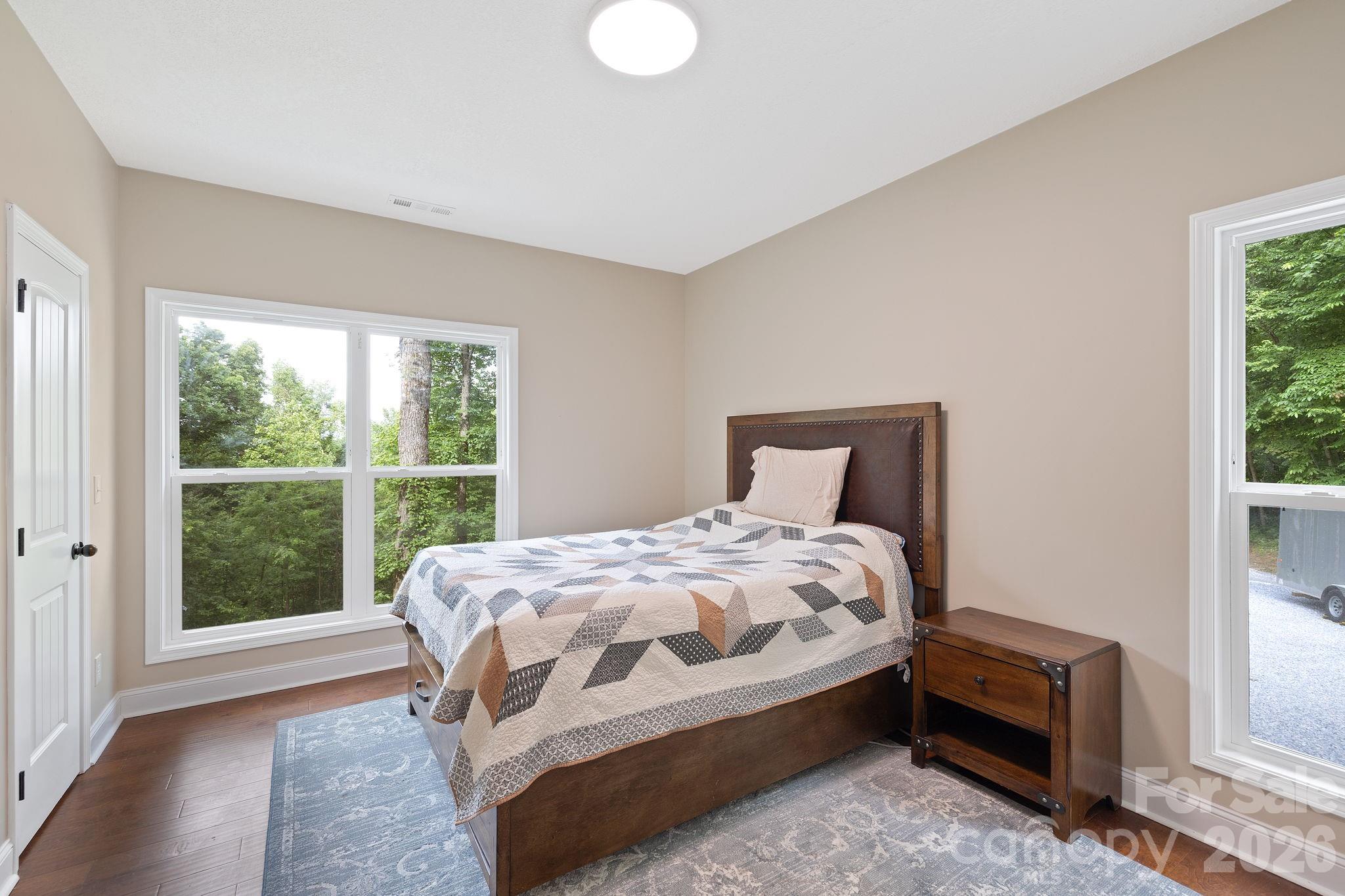771 Sally Gap Road Old Fort, NC 28762 - Photo 14 of 44 a bedroom with a bed and a window