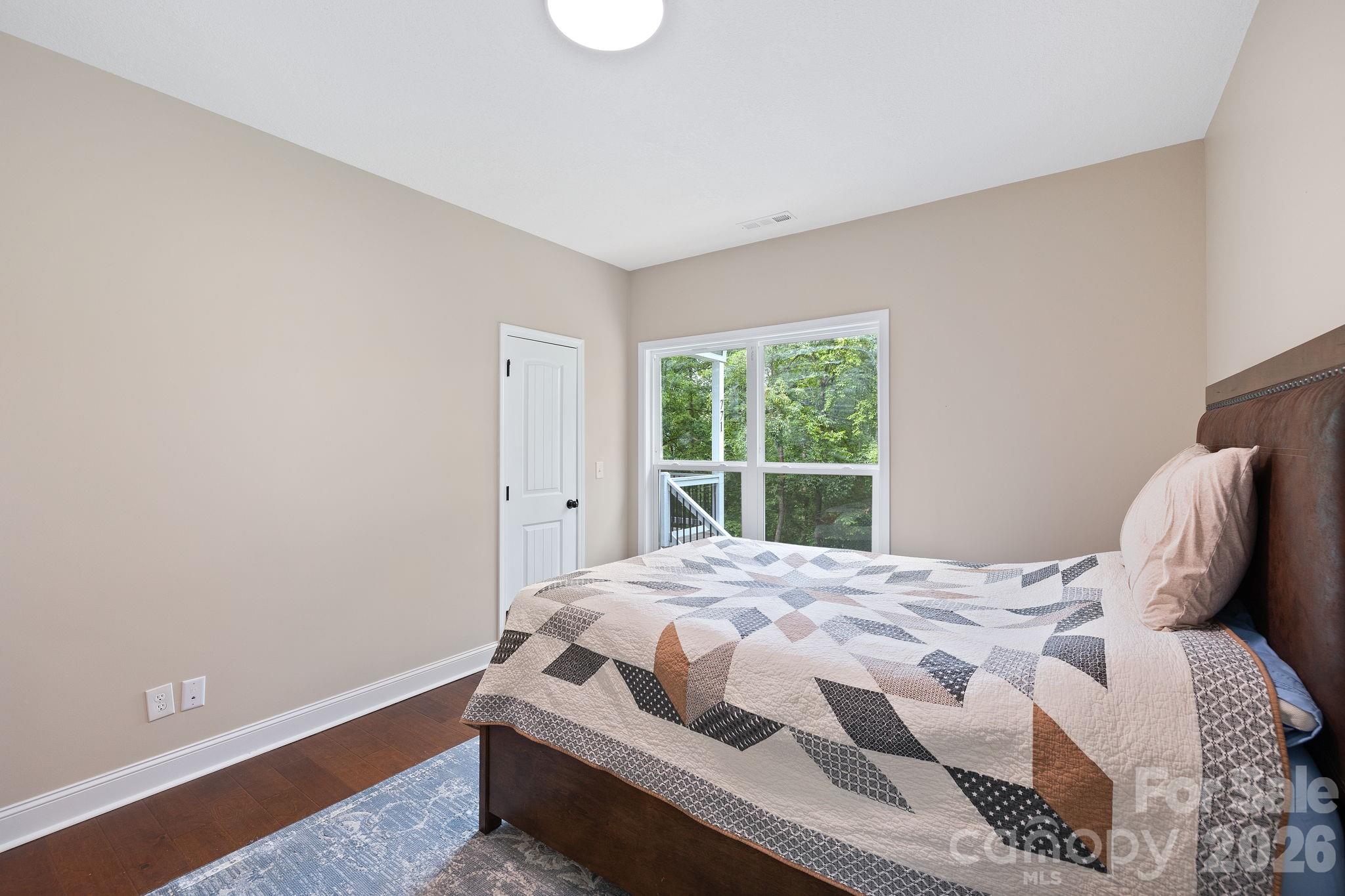 771 Sally Gap Road Old Fort, NC 28762 - Photo 15 of 44 a bedroom with a bed and window