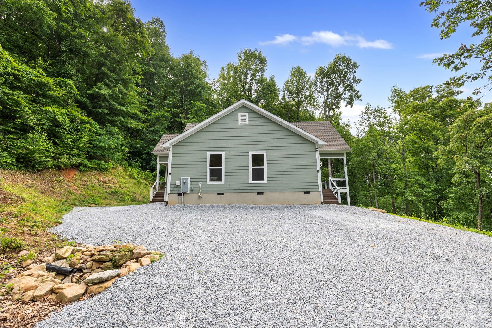 771 Sally Gap Road Old Fort, NC 28762 - Photo 20 of 44 a front view of a house with a yard and garage