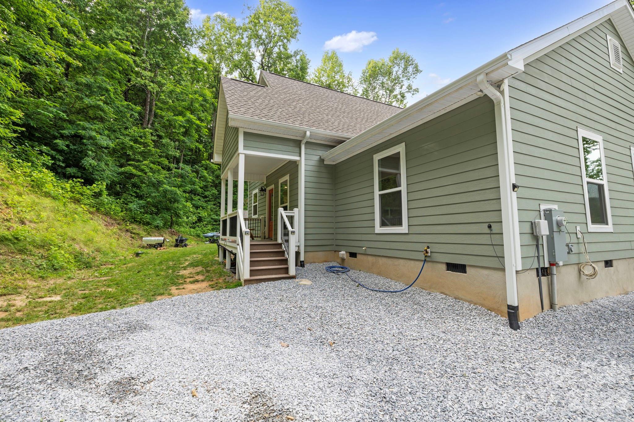 771 Sally Gap Road Old Fort, NC 28762 - Photo 21 of 44 a view of a house with backyard and a tree