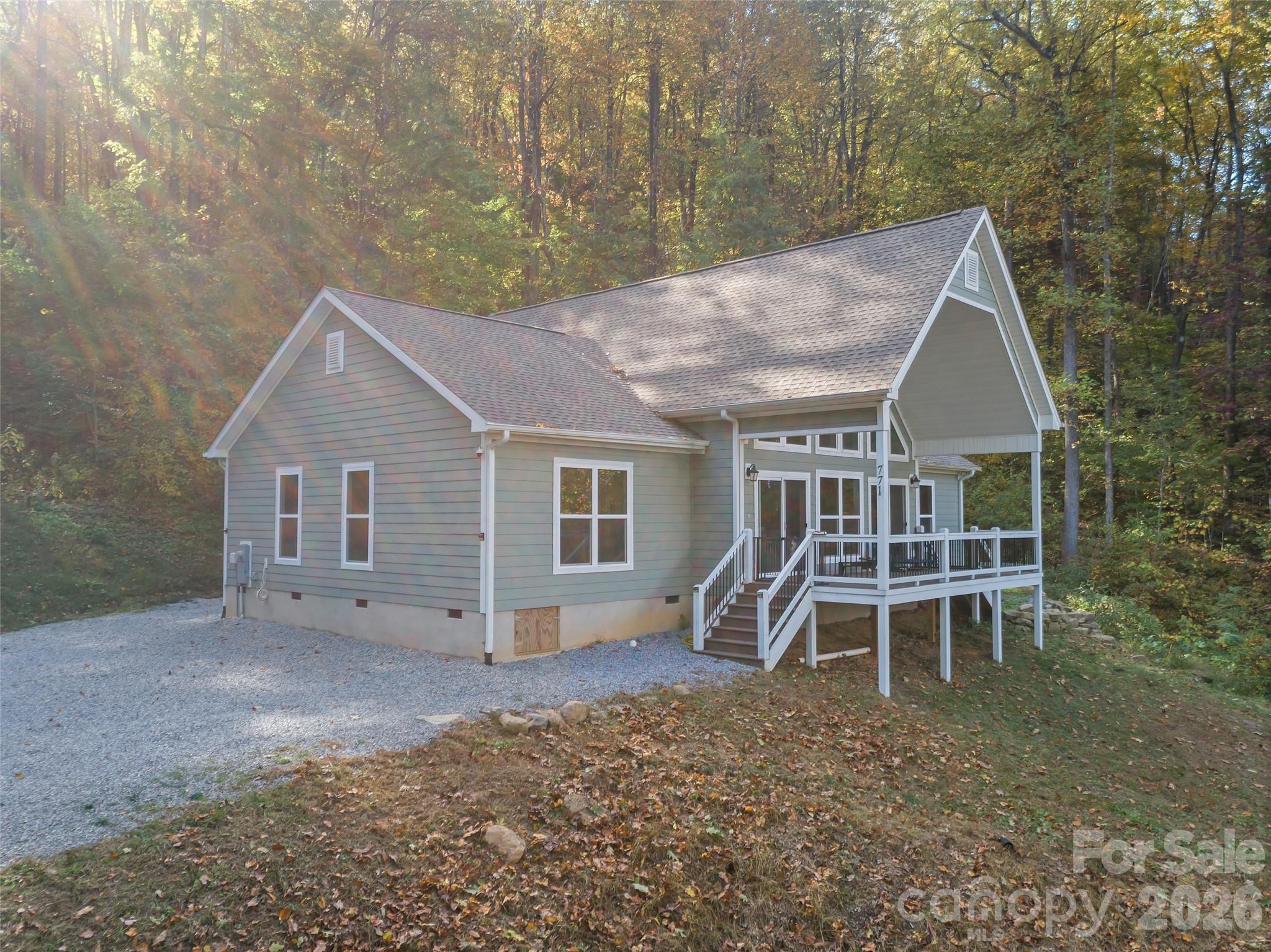 771 Sally Gap Road Old Fort, NC 28762 - Photo 24 of 44 a view of a house with a yard and sitting area