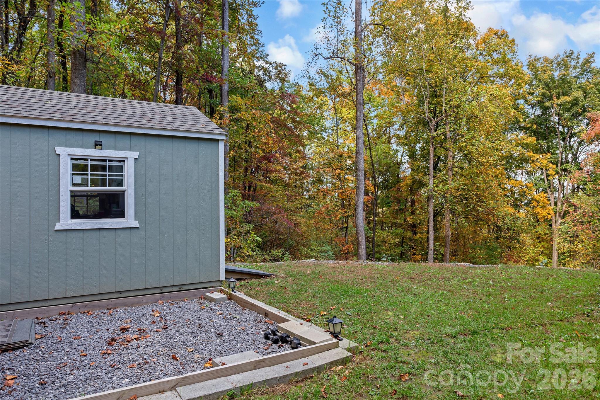 771 Sally Gap Road Old Fort, NC 28762 - Photo 30 of 44 a view of a backyard with plants and large trees