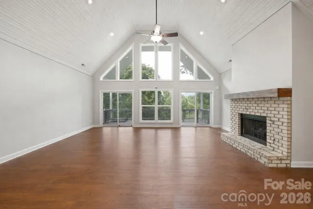 a view of an empty room with a fireplace and a window