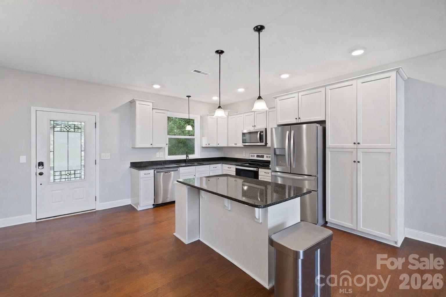 771 Sally Gap Road Old Fort, NC 28762 - Photo 7 of 44 a kitchen with kitchen island a sink stainless steel appliances and white cabinets